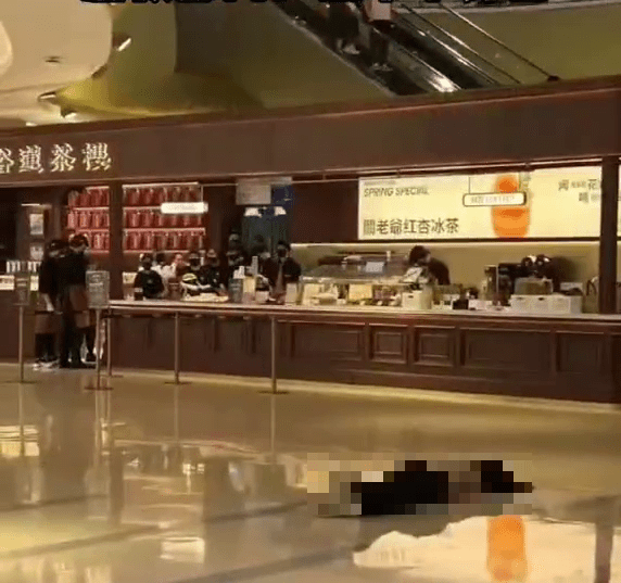 网上流传女子躺在商场一楼一间茶楼柜台前的地板上没有动静。